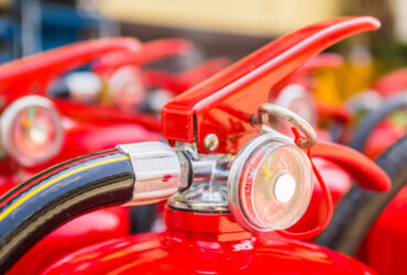 Fire Extinguisher Red fire extinguishers available in fire emergencies.
[[** Note: Shallow depth of field
** Note: Visible grain at 100%, best at smaller sizes
